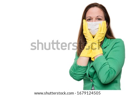 Portrait of young woman with face mask and yellow gloves holding her face, isolated on white background