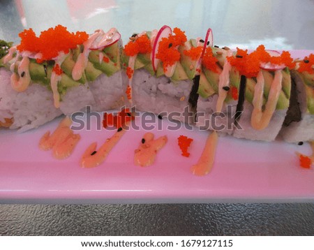 dragon roll sushi on colorful table white plate