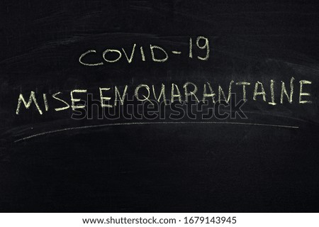 French word: Quarantine. The text on the chalk Board. Yellow chalk