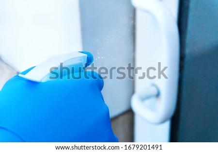 Coronavirus COVID-19. Prevention cleaning many hand sprays doorknob with antibacterial disinfecting fluid for killing coronavirus on touching surfaces or touching public door handle with tissue. Royalty-Free Stock Photo #1679201491