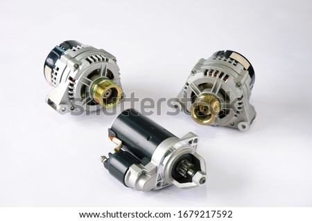 Spare parts for repairing the car's electrical equipment. Generators and starter on the white surface of the table, top view. Royalty-Free Stock Photo #1679217592