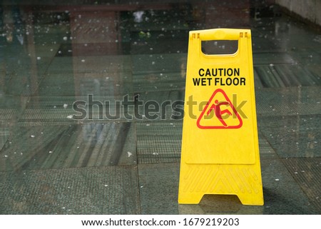 close up of warning sign for wet floor, caution and dangerous 