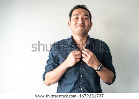 Portrait of young man button up shirt looking camera on white background.