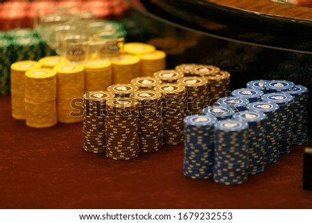 Gaming chips are on the card table. Smooth rows of playing chips in a casino.