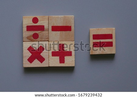 Top view of wooden Addition, subtraction, multiplication and division. They are four basic operations of elementary arithmetic.
