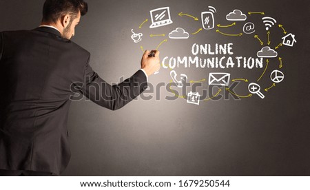 businessman drawing social media icons with ONLINE COMMUNICATION inscription, new media concept