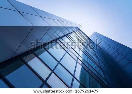 perspective, the skyscraper is directed to the sky. blue gradient, light reflection in glass, urban building design Royalty-Free Stock Photo #1679261479