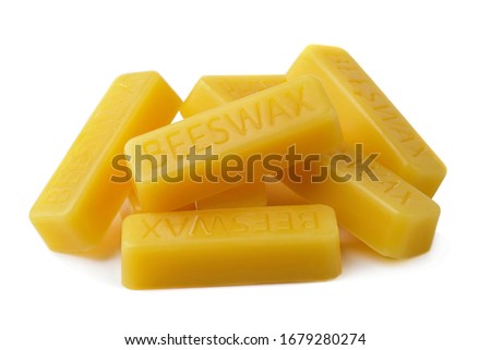 Beeswax on a white background.Beeswax blocks. Natural beeswax. Royalty-Free Stock Photo #1679280274