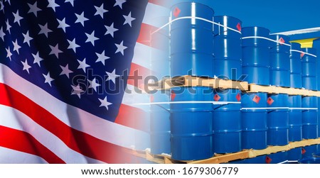Blue metal barrels stand on pallets. Barrels marked with flammable liquids. GHS Hazard pictograms. Export of flammable chemical liquids to the United States.