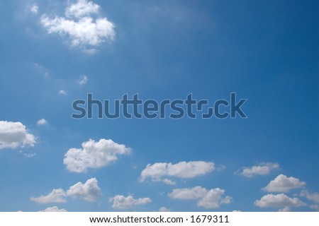 The blue sky with fluffy clouds
