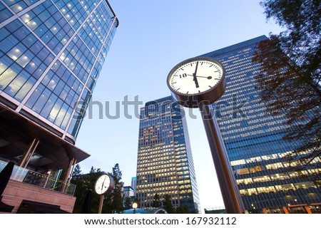 Clock in Canary Wharf in London's financial district office building, time in business concept  Royalty-Free Stock Photo #167932112