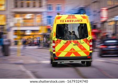 Back view of emergency ambulance car in the street Royalty-Free Stock Photo #1679324740