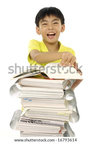 Portrait of schoolboy reading story with heap of books