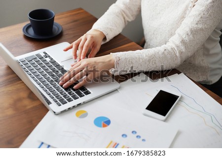 A woman in a suit doing telework at home Royalty-Free Stock Photo #1679385823