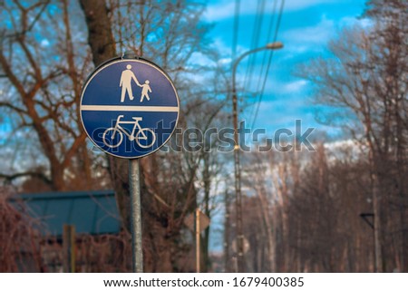 Signs ans signals for cyclists and pedestrians. Blue road signs on spring background.