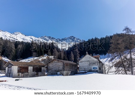 A lonely old farm on the empty and deserted ski slopes during the corona virus lockdown in the Swiss Alps