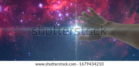 a human hand cover the light stroke frome the night star sky. elements of this image furnished by nasa
