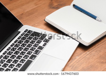 Laptop on wooden desk, taken in studio