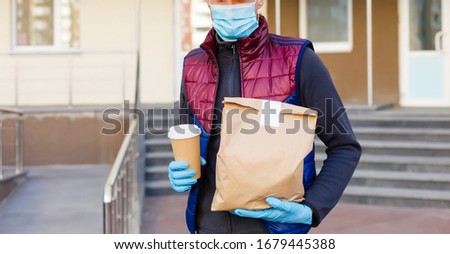 delivery man delivers orders. Delivery service under quarantine, disease outbreak, coronavirus covid-19 pandemic conditions.