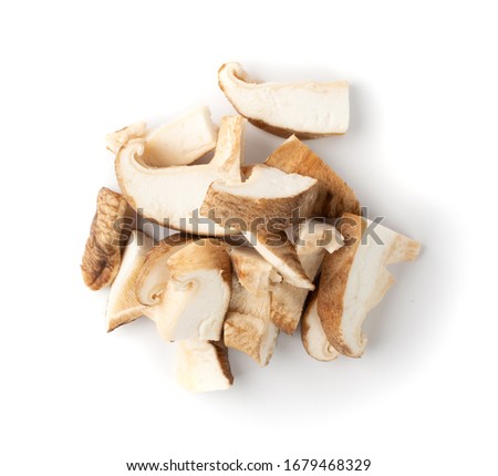 Pile of fresh sliced shiitake mushrooms isolated on white background. Raw chopped shitake, healthy organic asian fungi top view Royalty-Free Stock Photo #1679468329