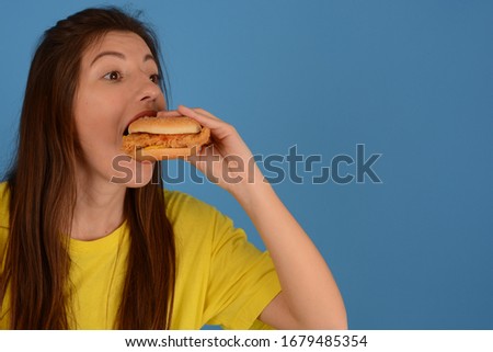 young woman eating tasty burger fast food food advertisement