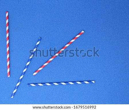 Paper straws colored, blue background