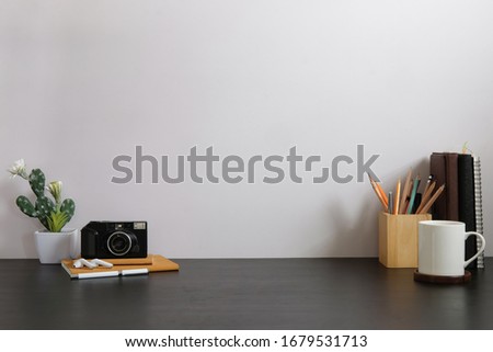 Mockup workspace desk and copy space books,plant and coffee on wood desk. Royalty-Free Stock Photo #1679531713