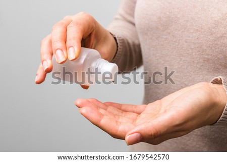 closeup clean woman hands using sanitiser to disinfect her hands. hygiene respt