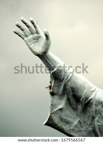 Close up of hand of Jesus raises with background white cloud
