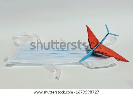 Protective face mask and airplane model on white background, against Wuhan coronavirus covid-19 and Influenza. Antiseptic, Hygiene and Healthcare concept