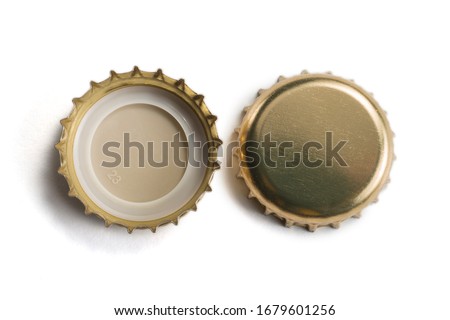 Top view of Golden crown caps without logos isolated on white background Royalty-Free Stock Photo #1679601256
