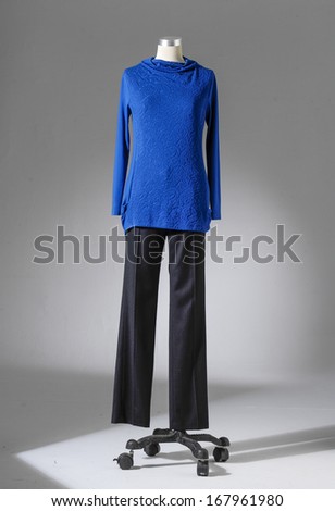 full-length female blue dress and trousers on mannequin  