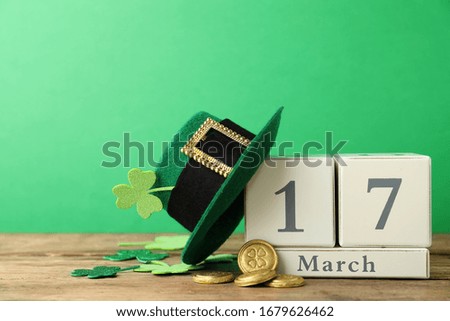 Composition with block calendar on wooden table. St. Patrick's Day celebration
