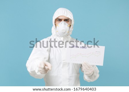 Man in protective suit respirator mask hold in hand infographic recovery death isolated on blue background studio. Epidemic pandemic rapidly spreading coronavirus 2019-ncov medicine flu virus concept