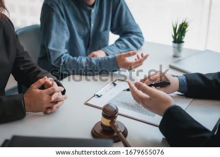 Business people and lawyers talk and contract together. Signing of a contract in the presence of an attorney.