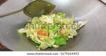 Stir fried cabbage with fish sauce and dried shrimp in Thai Style on wok Royalty-Free Stock Photo #1679664493