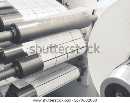 Photo production. Label winding in rolls. Royalty-Free Stock Photo #1679682088