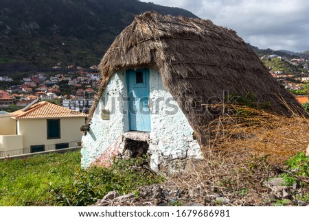 Little small, triangular, thatched-roof house (santana house) in the village Machico , picture from Machico Madeira, Portugal.