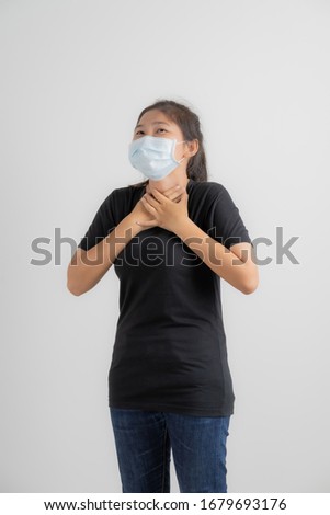 Close up portrait of young woman with medicine health care mask against white white background. CoronaVirus, Covid-19. Asian people