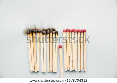 concept to stop the coronavirus COVID-19 from spreading -Matchsticks burn and one piece prevents fire from spreading, Social distance or stay at home Royalty-Free Stock Photo #1679704312