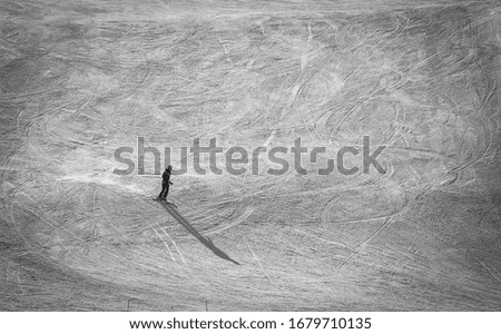 Skiing alone in ski hill in black and white