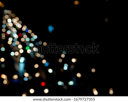 Blur picture of Bangkok at night, multicolored circle, bokeh is the car light on the road. Dot color and dark for background. Night light in the city.  Abstract photo for creative media & advertising
