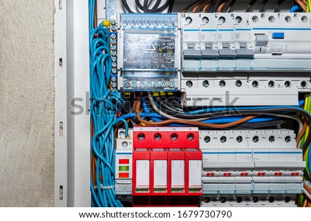 Surge arrester used to protect the electrical system in the building during electrical discharges, storm protection and three-phase fuse. Royalty-Free Stock Photo #1679730790