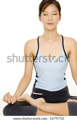 A pretty young asian woman meditating in a sitting yoga position