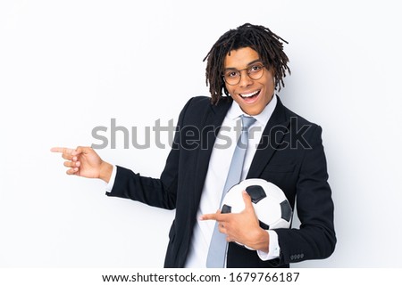 Soccer coach over isolated white background surprised and pointing side
