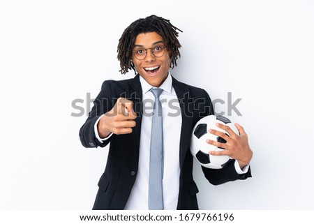 Soccer coach over isolated white background surprised and pointing front