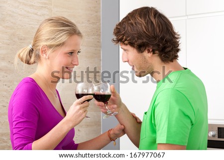 Young couple starting romantic dinner with wine