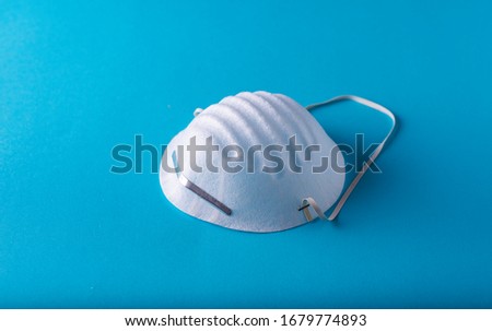 
single-use protection masks on a blue background Royalty-Free Stock Photo #1679774893