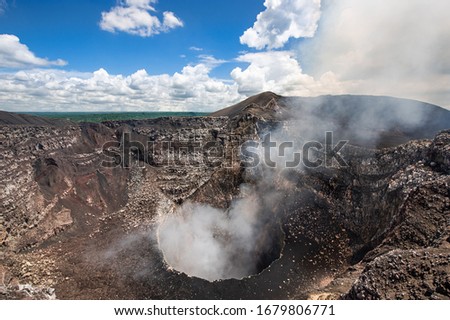 Masaya Volcano in Nicaragua active santiago crater kettle with lava and sulfur dioxide gas smoke column of steam emission perfect wide angle shot  Royalty-Free Stock Photo #1679806771