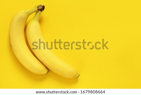 Yellow bananas on a yellow background with place for text. Bright colors. Flat lay